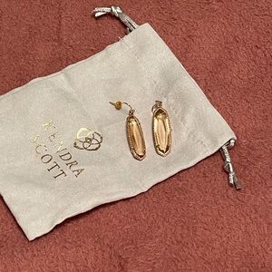 Peach Kendra Scott earrings.